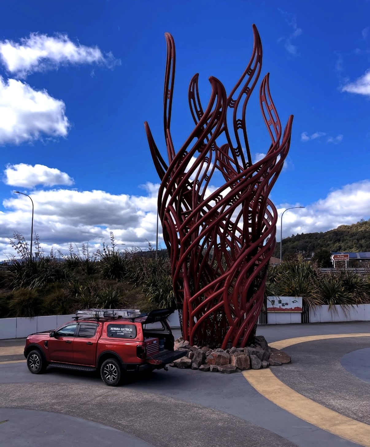 Hepburn Electrical truck beside a sculpture in Rotorua